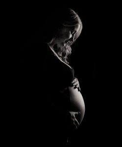 A pregnant woman practicing gentle stretches